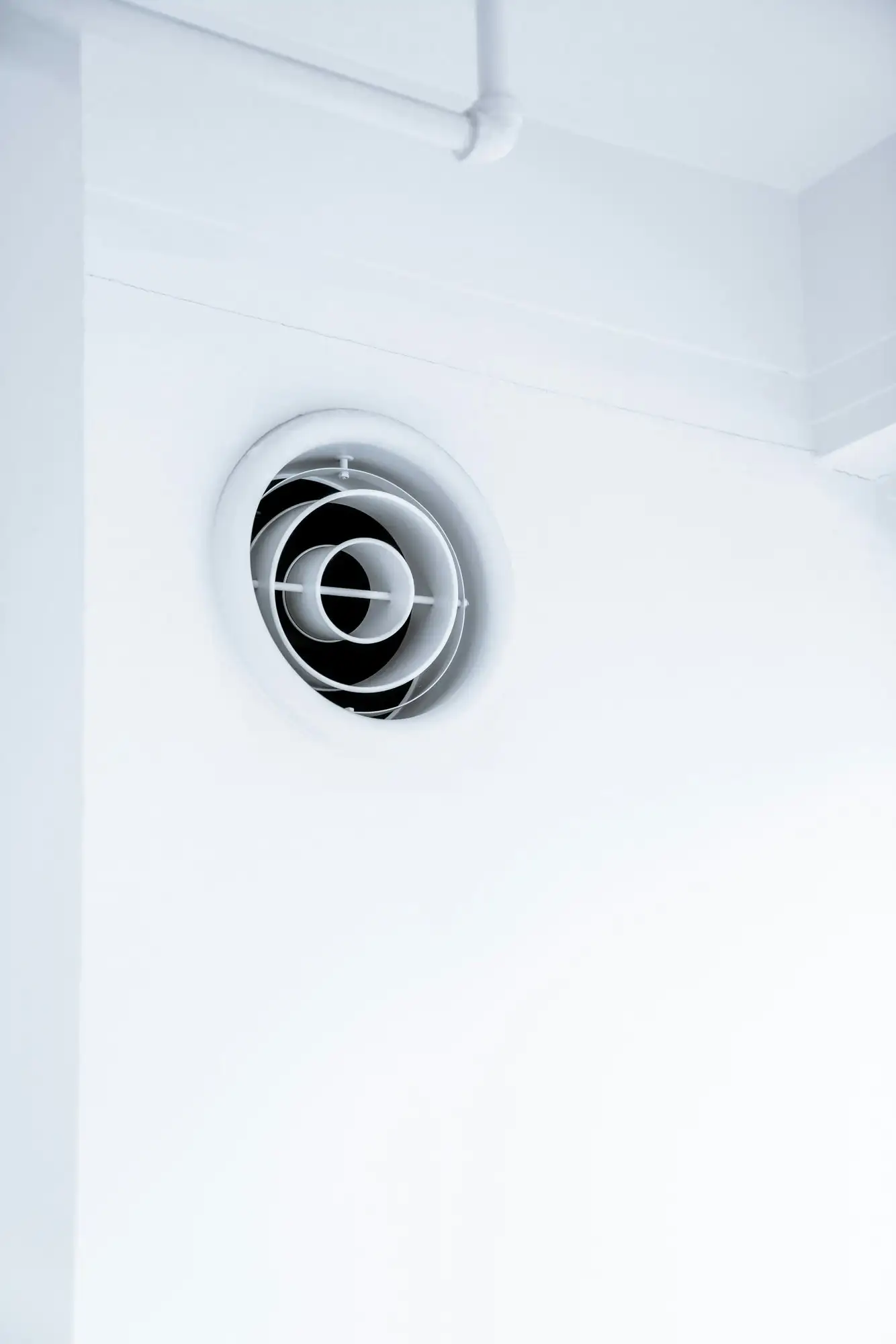 Round ceiling air diffuser on a white ceiling